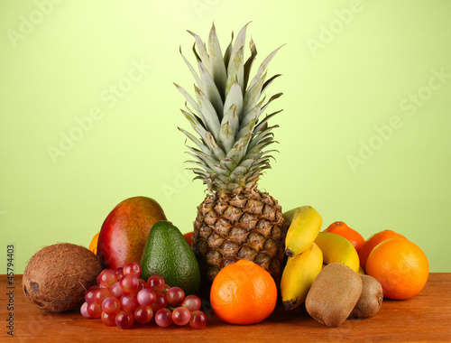 still life of fruit on a table on a green background