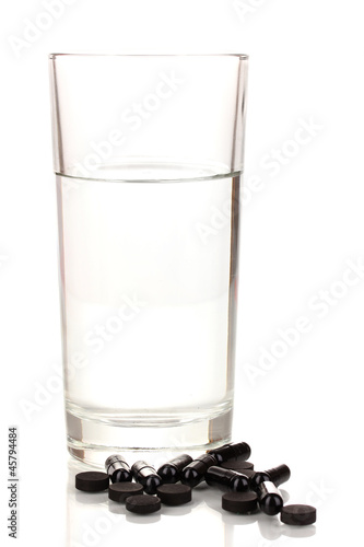 glass of water and activated carbon isolated on white