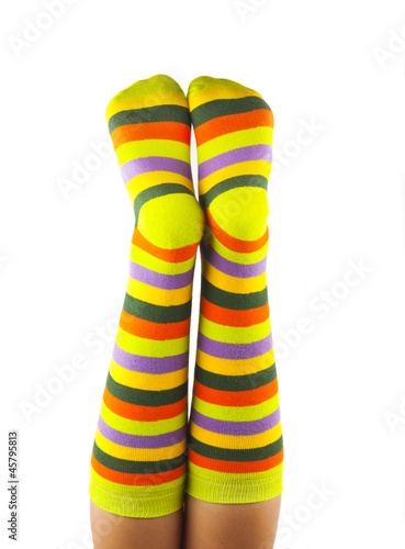 female legs in colorful striped socks