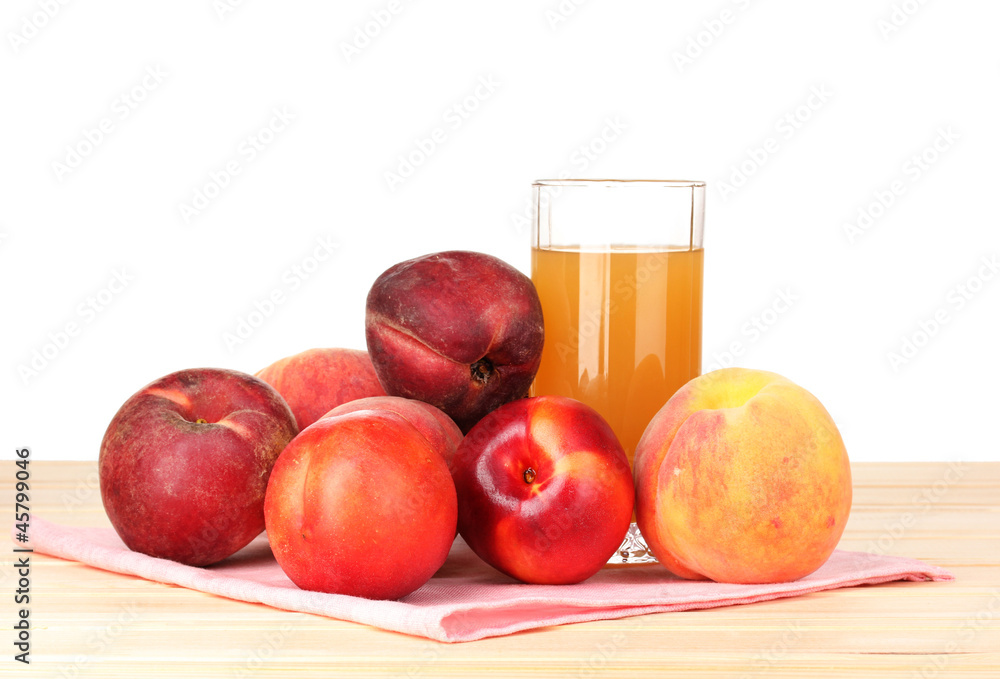 Ripe peaches and juice on wooden table on white background Ripe peaches and juice on wooden table on white background