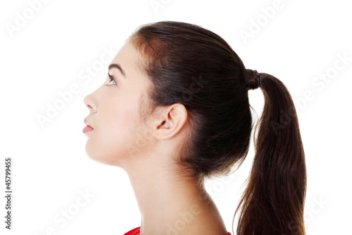 Portrait of a happy young woman looking up
