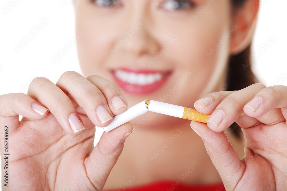 Young woman with broken cigarette.