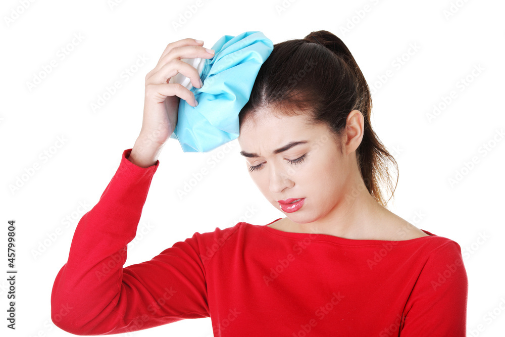 Woman with ice bag for headaches and migraines Woman with ice bag for headaches and migraines
