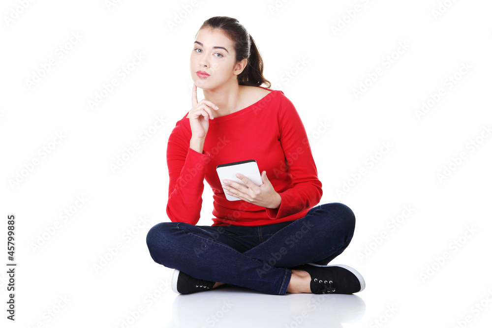 Woman sitting and working on tablet computer, Woman sitting and working on tablet computer,