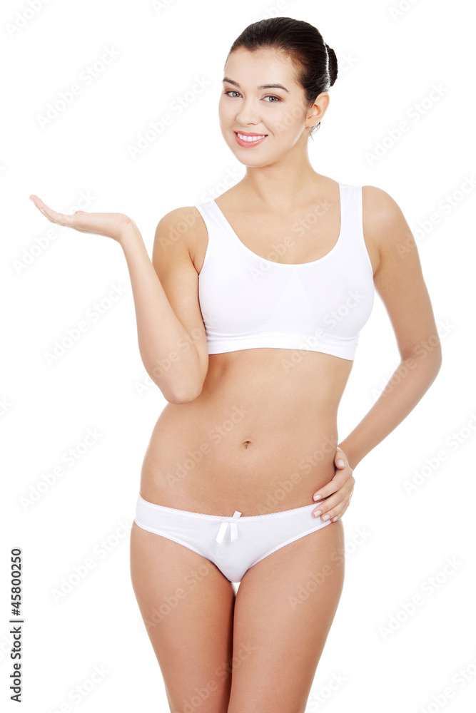 Portrait of a fit woman presenting something on hand Portrait of a fit woman presenting something on hand