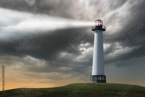Lighthouse beaming light ray over stormy clouds