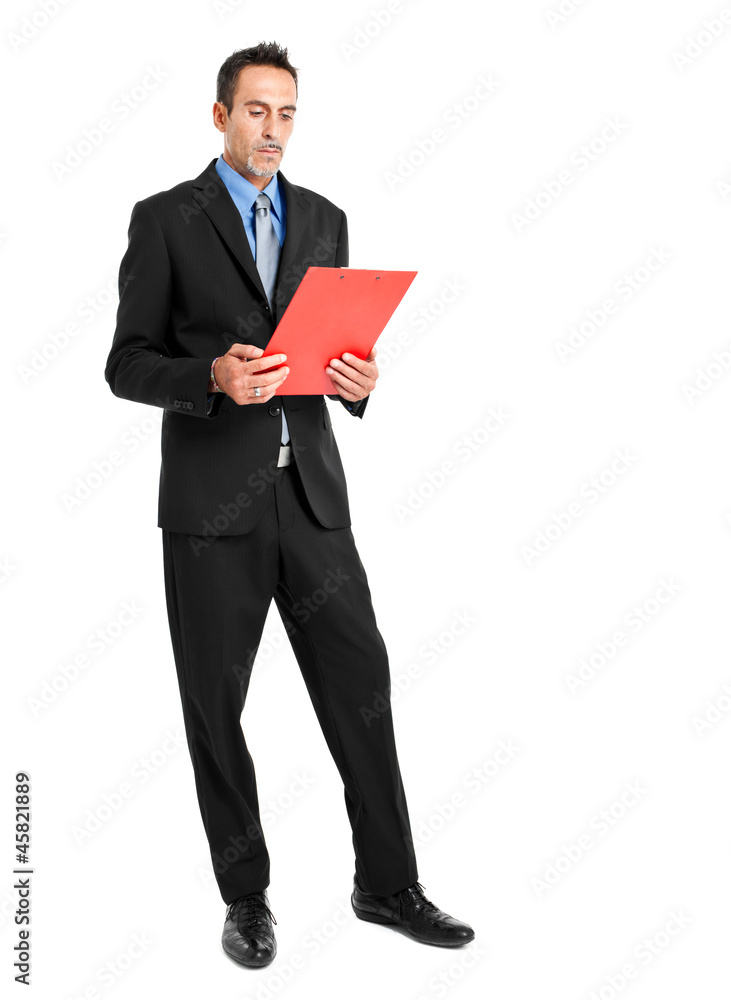 Full length businessman reading some documents Full length businessman reading some documents
