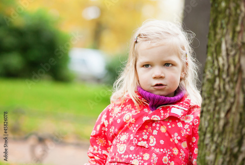 Outdoor autumn portrait of little girl