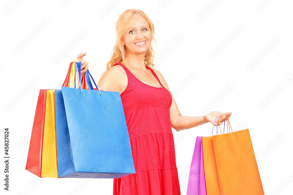 A mature woman holding shopping bags