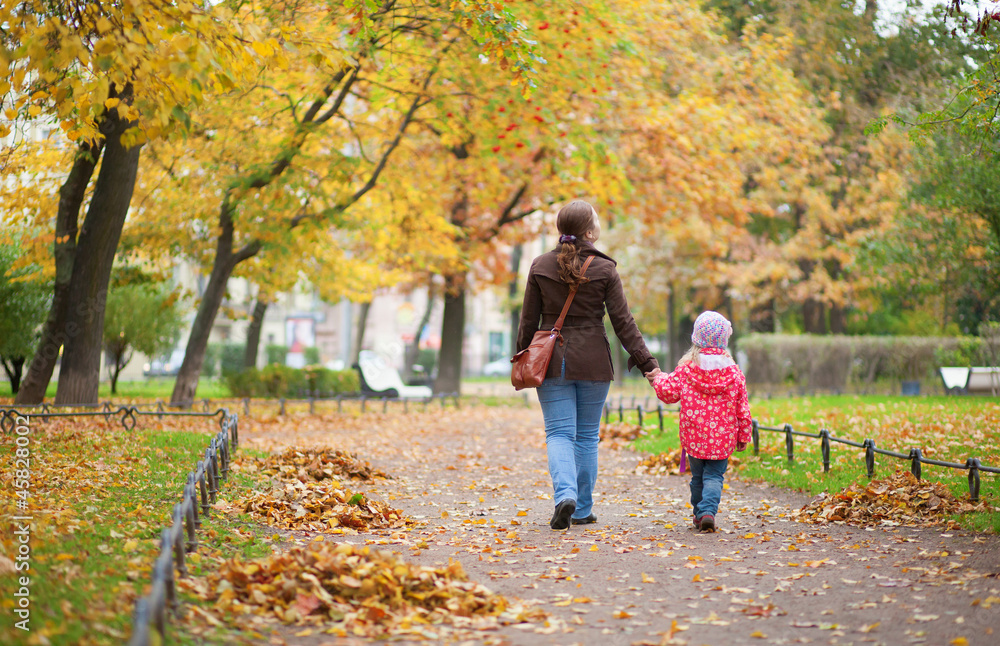 Mother and daughter walking together at beautiful autumn day Mother and daughter walking together at beautiful autumn day