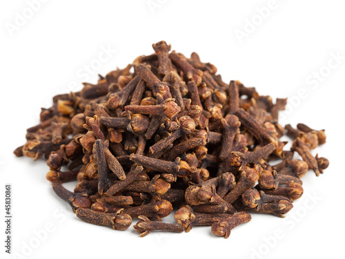 Heap of whole cloves on white background