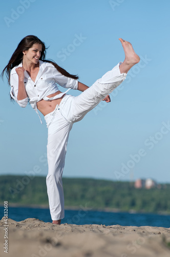Athletic woman performing a kick