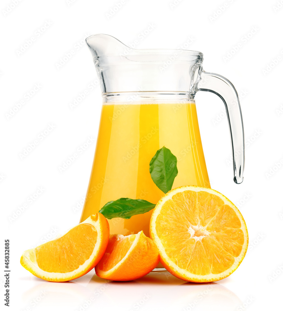 Orange juice in pitcher and oranges. Orange juice in pitcher and oranges.