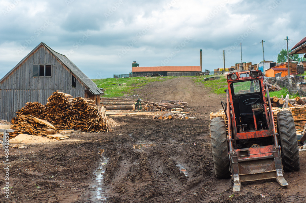 Fototapeta premium Wood industry outdoorsm with red tractor