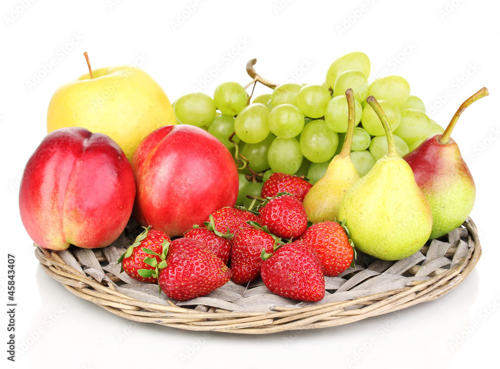 ripe sweet fruits and berries on wicker mat isolated on white ripe sweet fruits and berries on wicker mat isolated on white