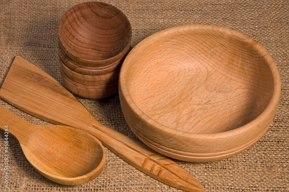 Wooden bowls and spoons on burlap Wooden bowls and spoons on burlap