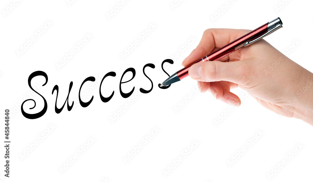 Hand with pen writing the word success Hand with pen writing the word success