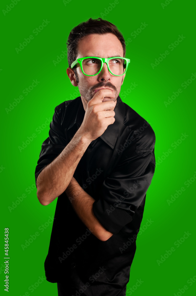 Obraz premium thoughtful man with green eyeglasses