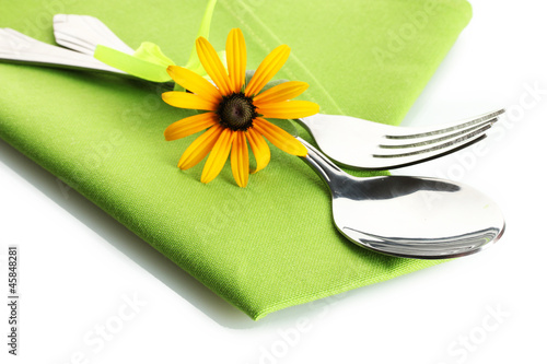 spoon, fork and flower on napkin, isolated on white