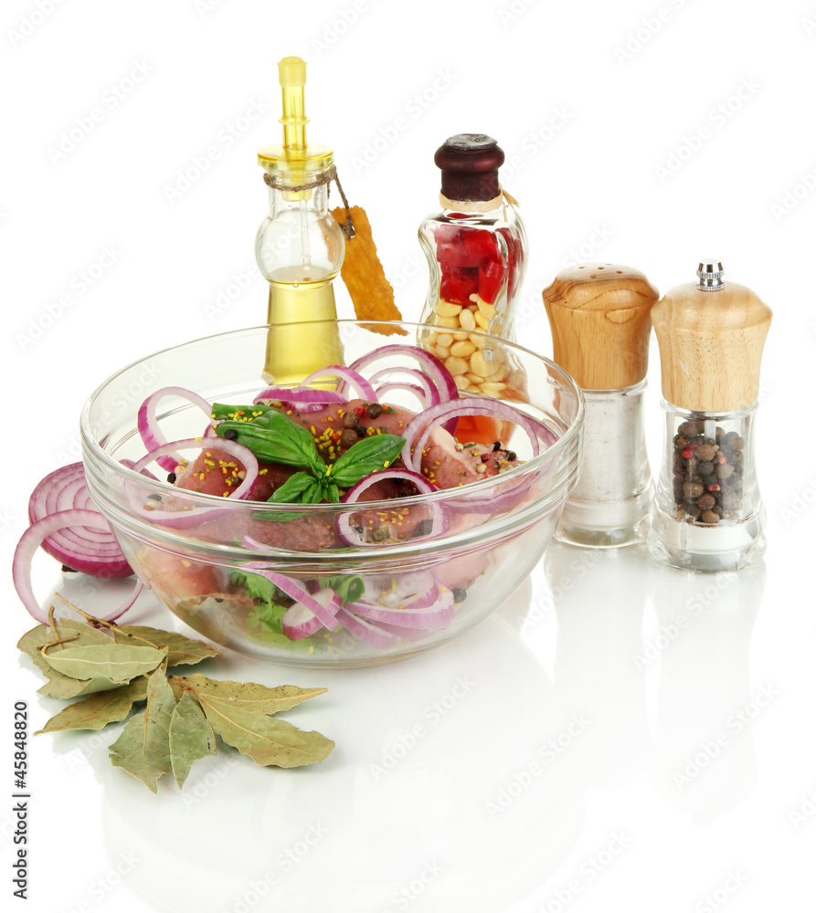 A large piece of pork marinated in bowl with herbs, spices and A large piece of pork marinated in bowl with herbs, spices and