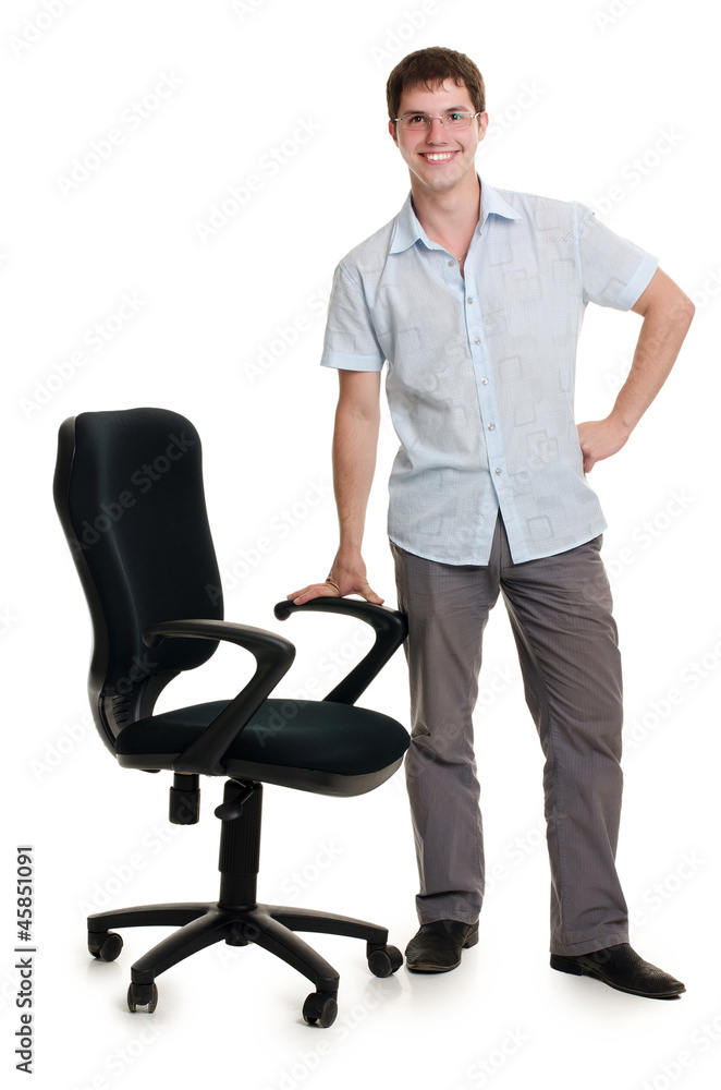 The businessman stands an armchair isolated