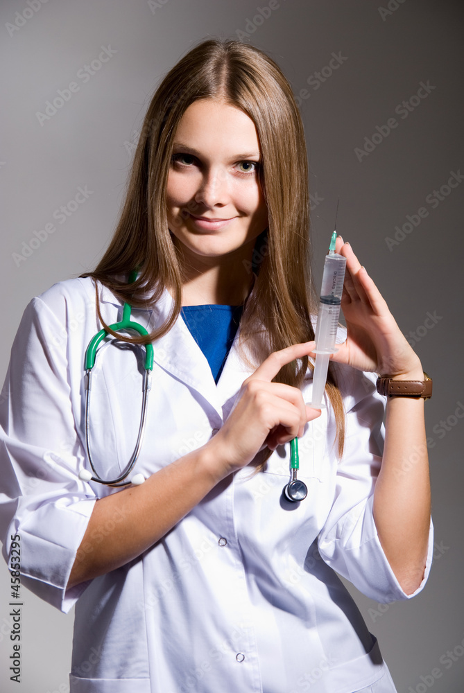 Doctor holding a syringe in his hand Doctor holding a syringe in his hand