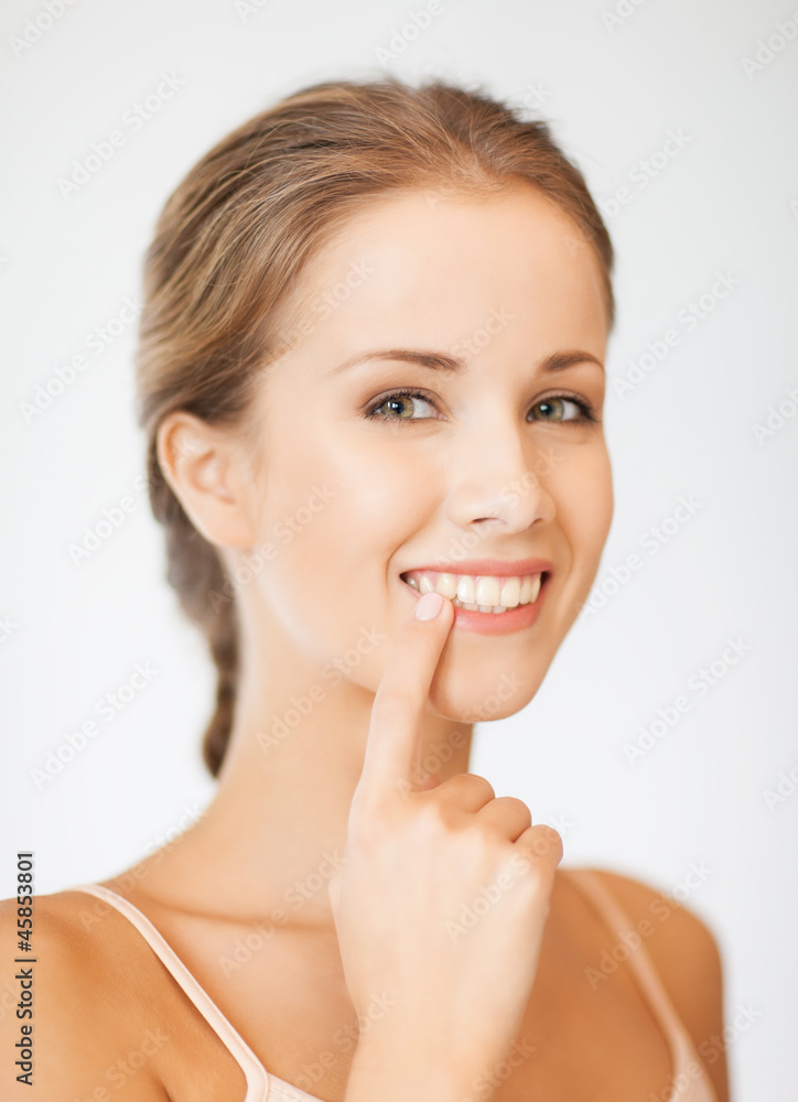 beautiful woman pointing to teeth beautiful woman pointing to teeth