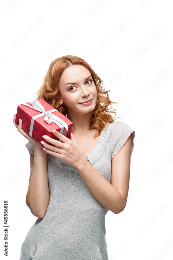 young thoughtful happy smiling girl holding gift young thoughtful happy smiling girl holding gift