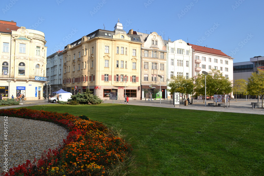 Naklejka premium Historic buildings on the square with lawn
