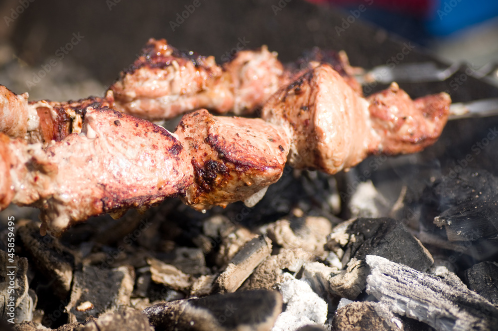 Appetizing hot sirloin beef on metal skewers