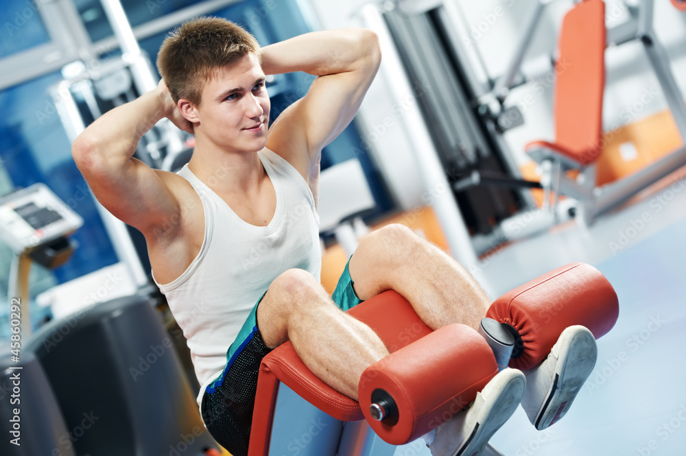 Fototapeta premium bodybuilding man at abdominal crunch exercises