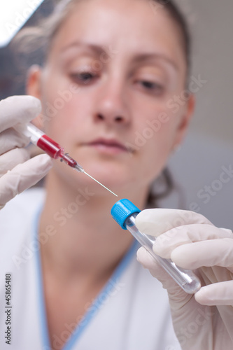 Injecting blood in test tube