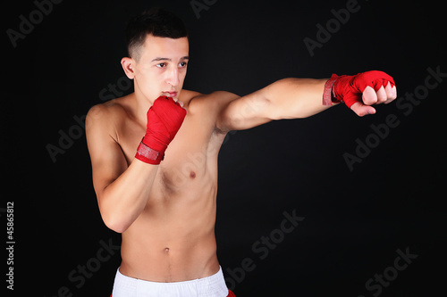 Young Boxer fighter over black background © Maksymiv Iurii