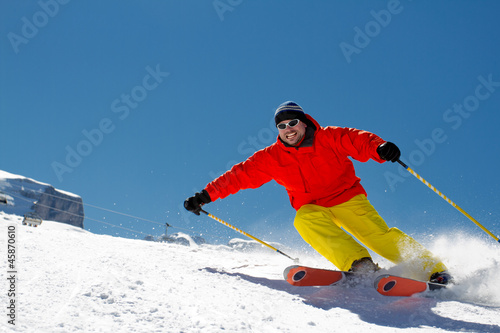 Freeride in fresh powder snow - man skiing downhill