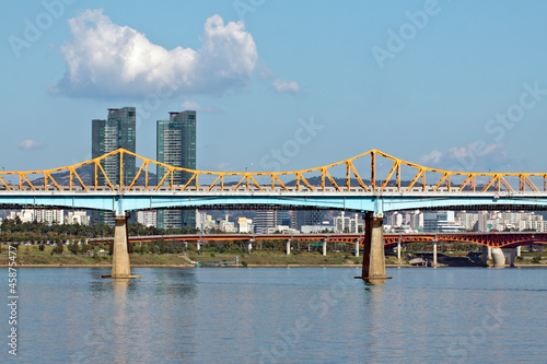 A bridge with a subway train over river in sunny afternoon