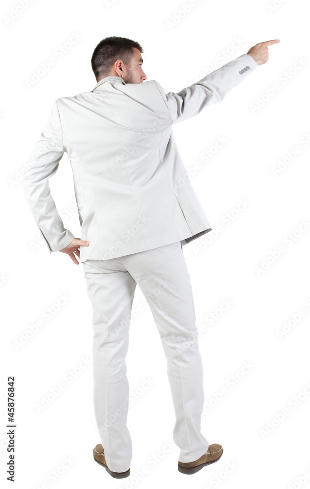 Back view of businessman pointing at wall. Back view of businessman pointing at wall.