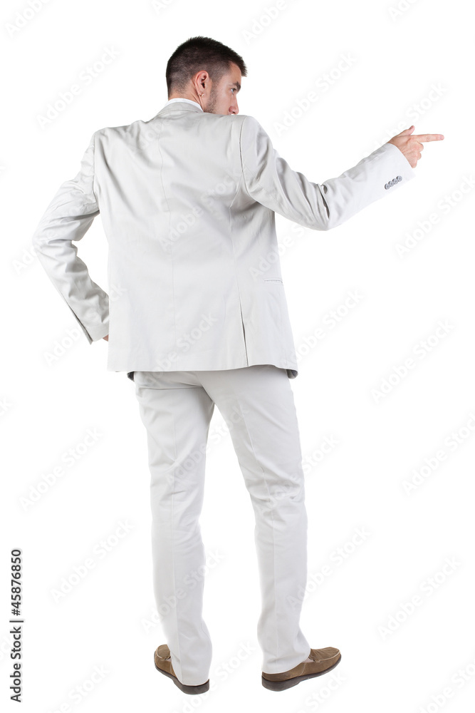 Back view of businessman pointing at wall Back view of businessman pointing at wall