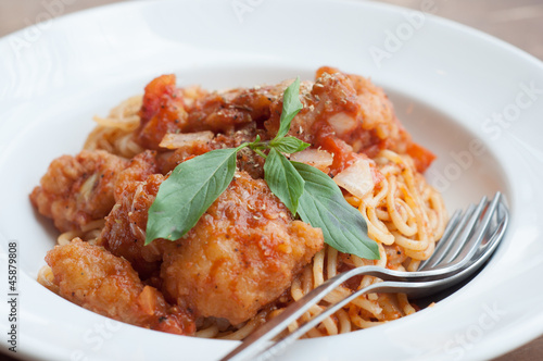 spaghetti with spicy fried fish on sauce