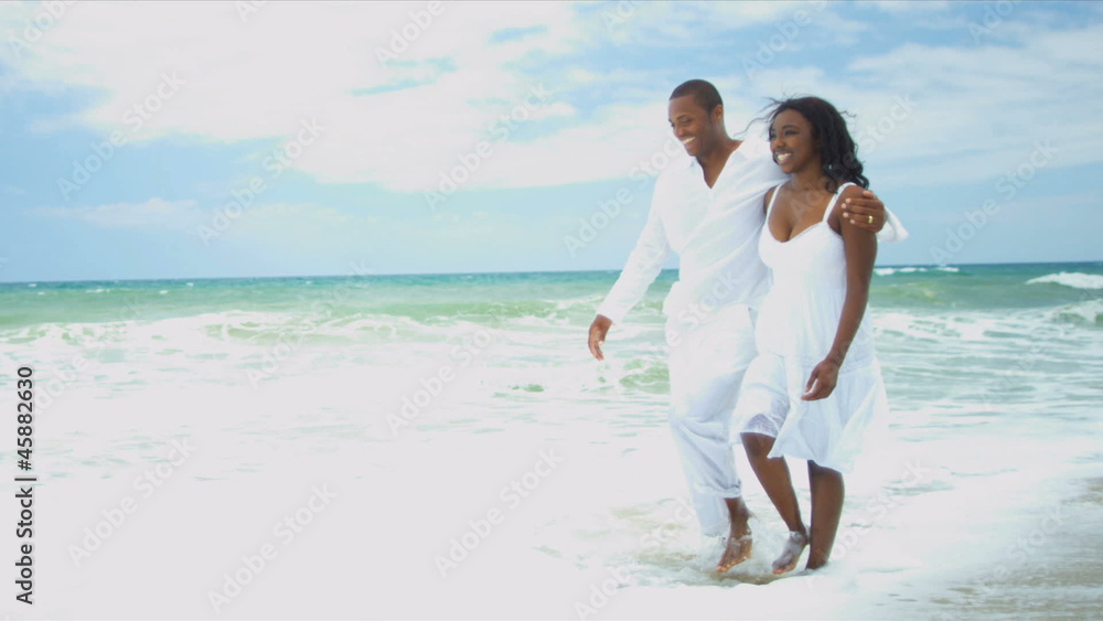 Happy ethnic girl enjoying time on beach with loving father Happy ethnic girl enjoying time on beach with loving father