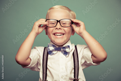 Cheerful smiling funny boy on a green background.