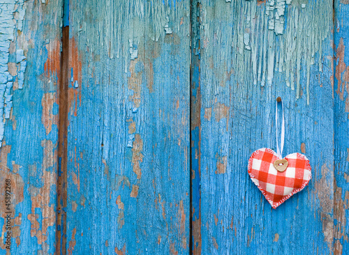 Small heart on woody background