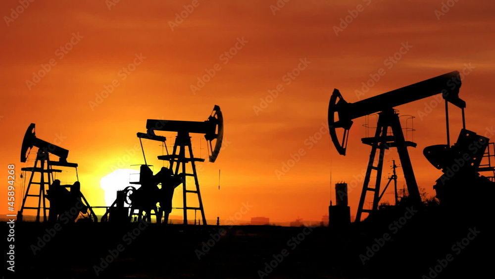 working oil pumps silhouette against timelapse sunrise working oil pumps silhouette against timelapse sunrise