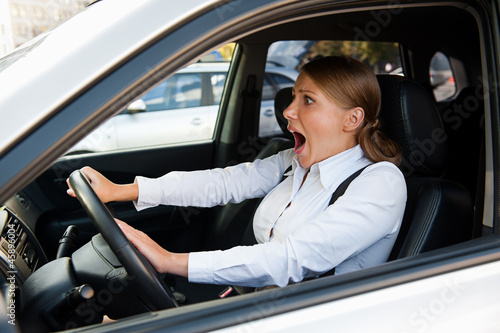 woman driving the car and honking © ArtFamily