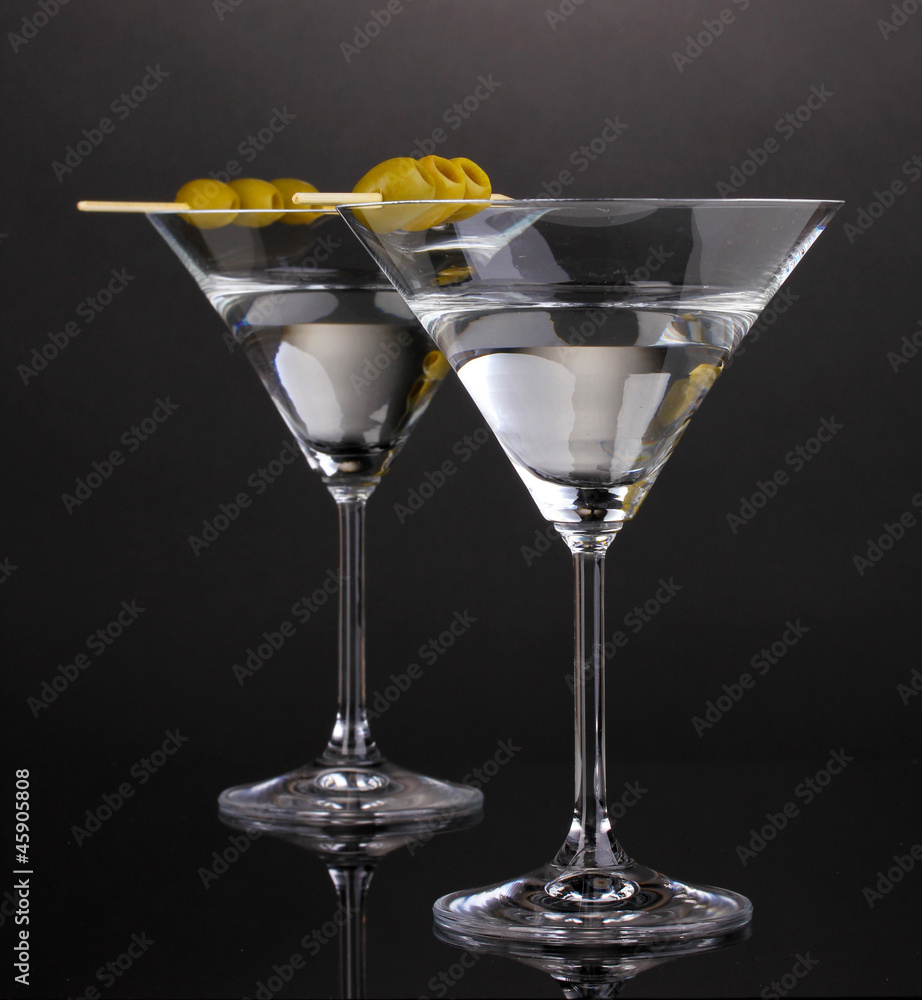 Martini glasses and olives on grey background Martini glasses and olives on grey background