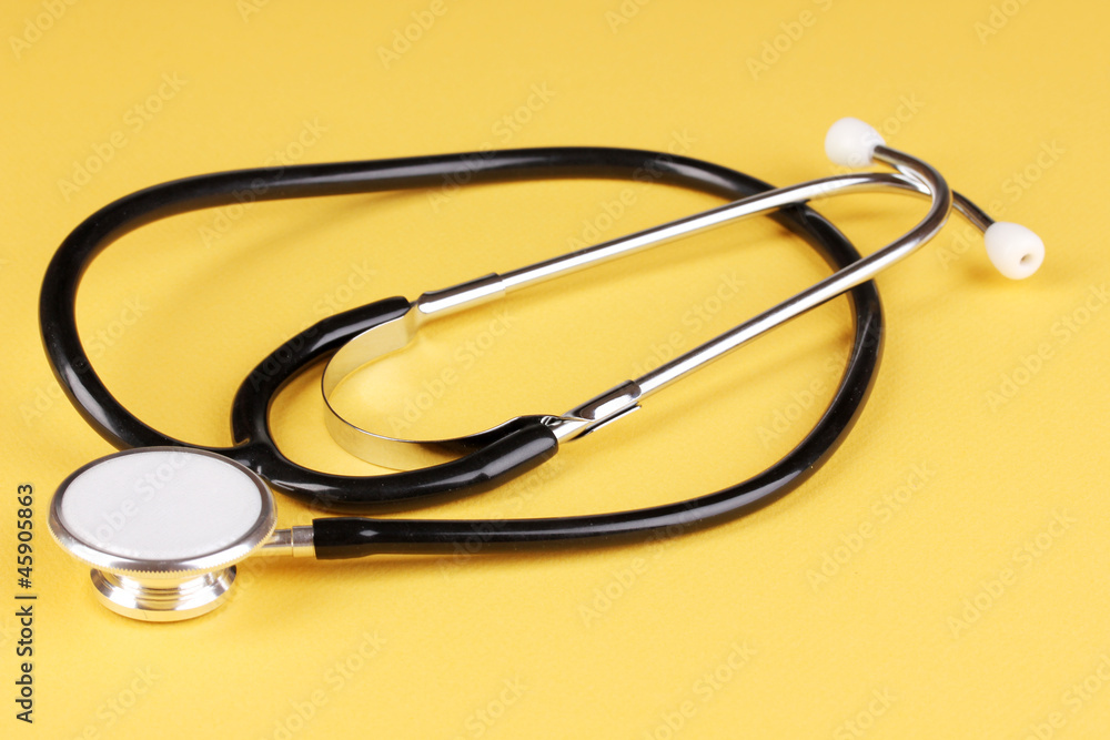 Stethoscope on orange background Stethoscope on orange background