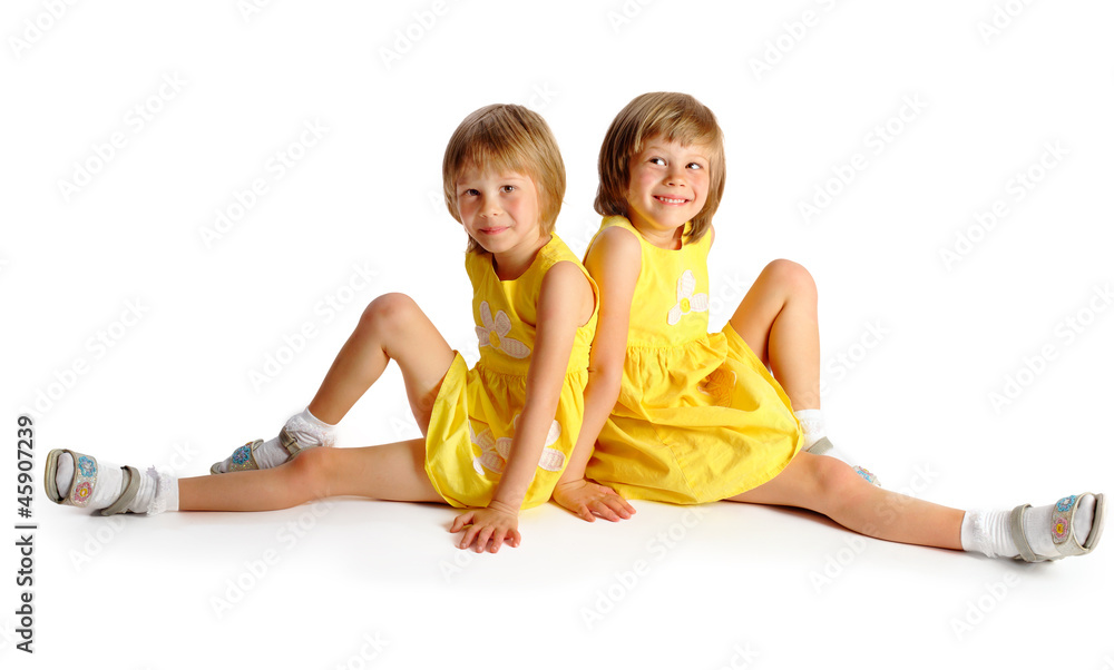 sisters twins in yellow bright dresses have fun in studio sisters twins in yellow bright dresses have fun in studio