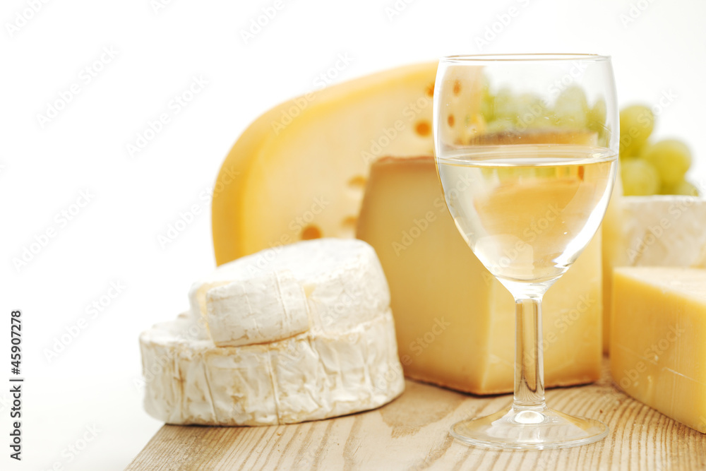 cheese and wine on a wooden table cheese and wine on a wooden table
