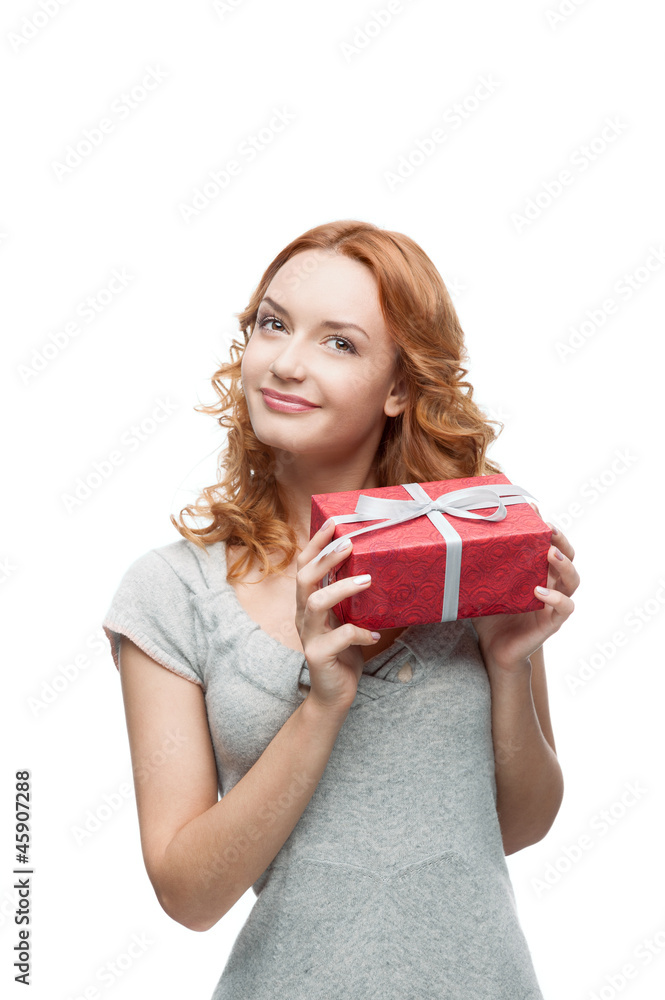 young red-haired happy smiling girl holding gift young red-haired happy smiling girl holding gift