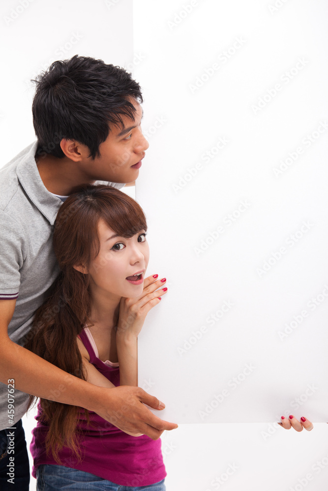 Young couple take white panel isolated on white background. Young couple take white panel isolated on white background.