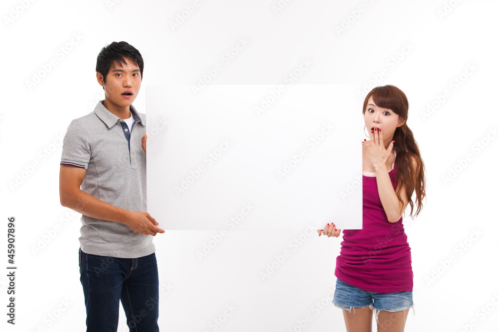 Young couple take white panel isolated on white background. Young couple take white panel isolated on white background.